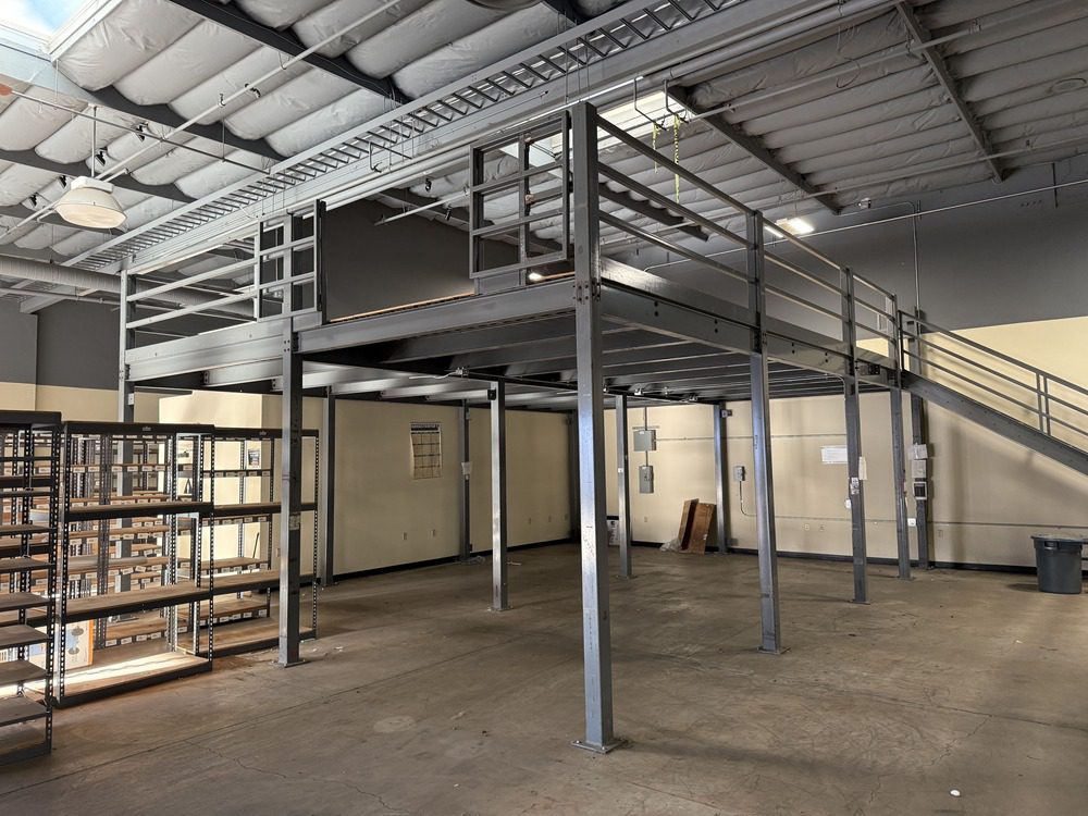 Steel mezzanine and stair assembly inside a commercial workspace