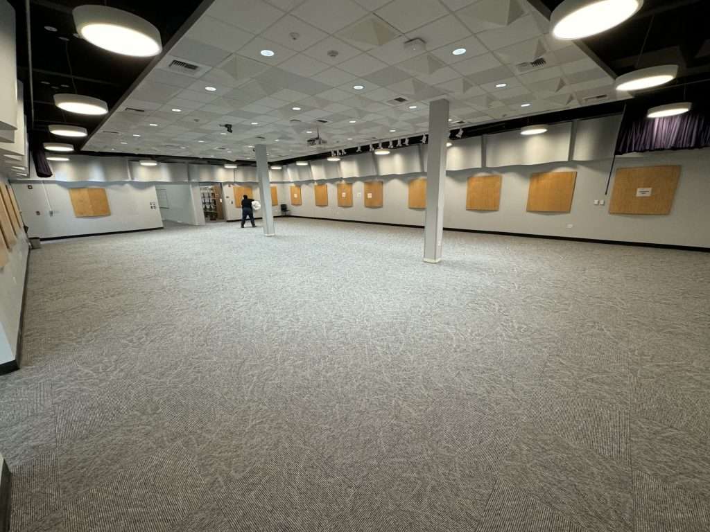 Completed Irvine Valley College A311 rehearsal studio with new modular carpet tile and finished wall openings connecting adjacent music rooms.
