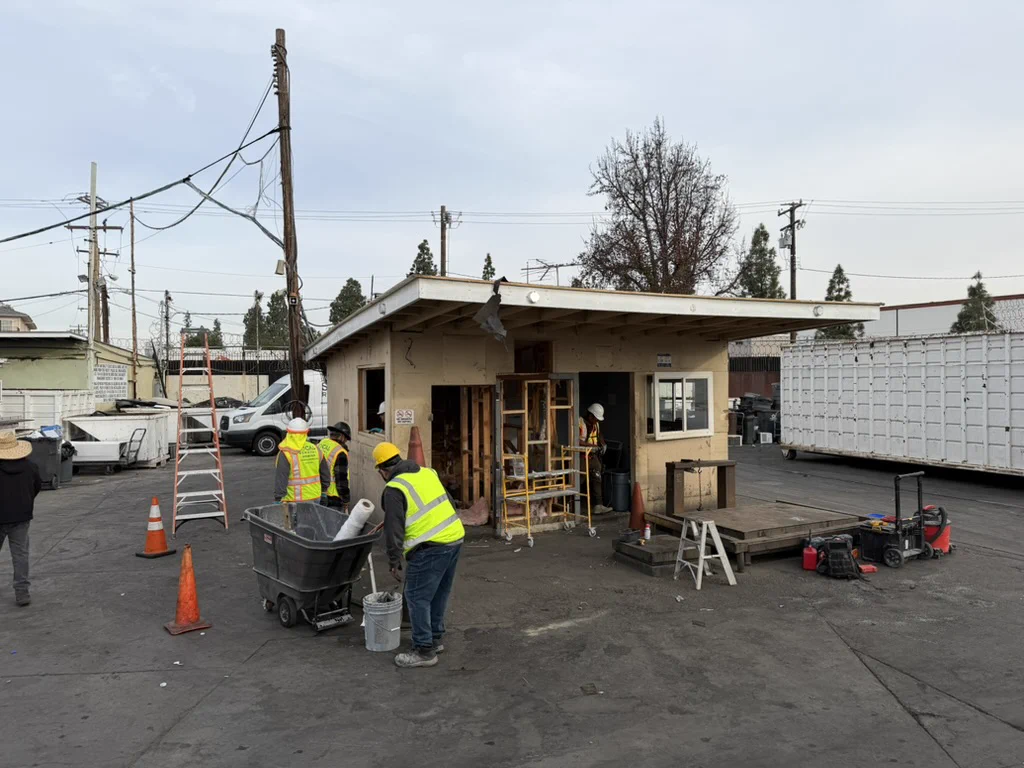 Demolition crew dismantling the office and cashier booth at the Bruce Metals property in Santa Ana.