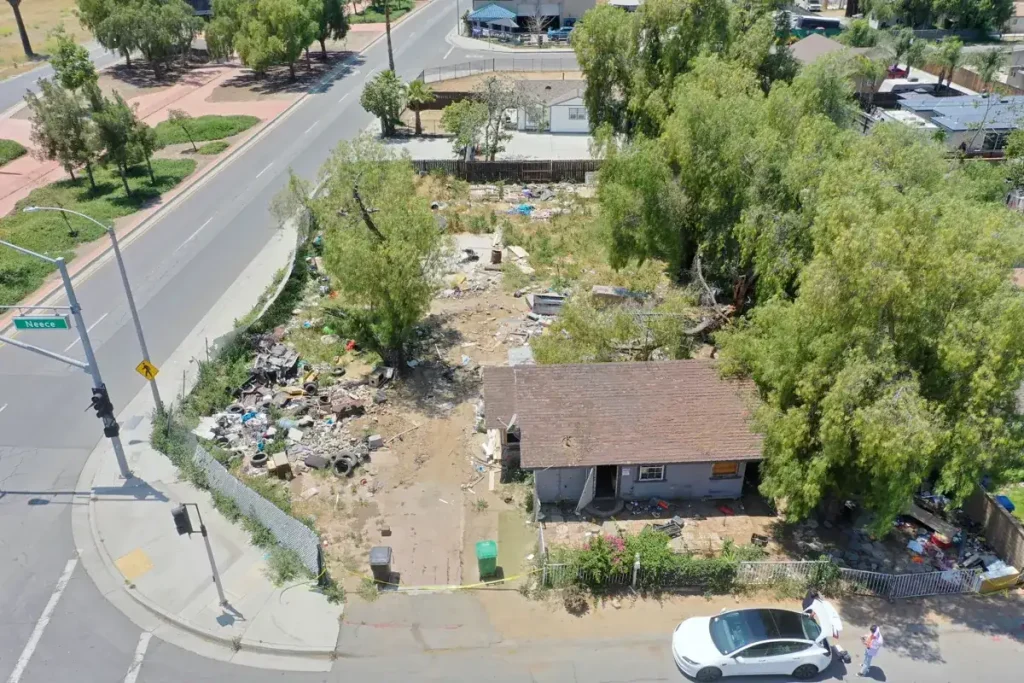 Deteriorated structure and surrounding lot before demolition