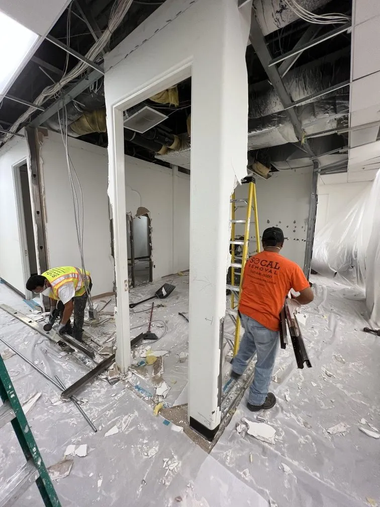 SoCal Removal crew performing controlled interior selective demolition beside retained finishes
