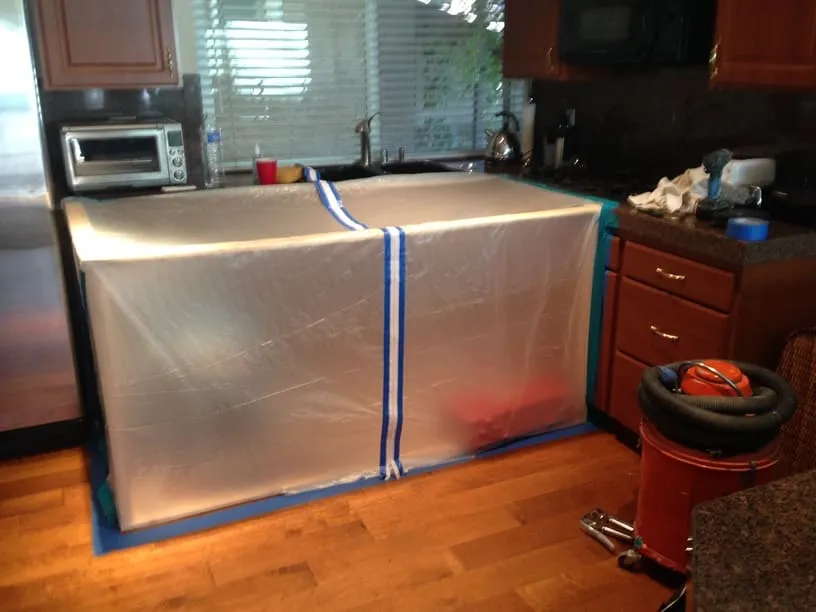 Interior kitchen work area isolated with temporary poly protection